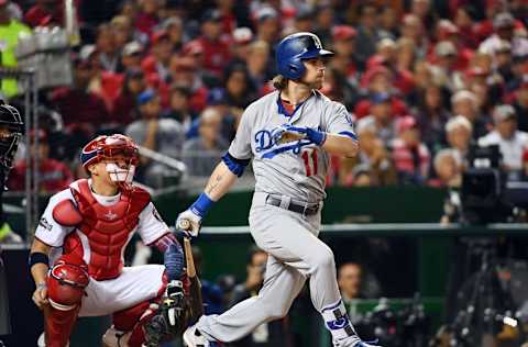 Oct 13, 2016; Washington, DC, USA; Los Angeles Dodgers right fielder Josh Reddick (11) hits a single during the fifth inning against the Washington Nationals during game five of the 2016 NLDS playoff baseball game at Nationals Park. Mandatory Credit: 