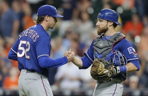 Sep 13, 2016; Houston, TX, USA; Texas Rangers catcher Robinson Chirinos (61) congratulates relief pitcher Tanner Scheppers (52) after defeating the dHouston Astros at Minute Maid Park. Texas won 3 to 2 . Mandatory Credit: Thomas B. Shea-USA TODAY Sports