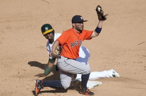 Sep 21, 2016; Oakland, CA, USA; Oakland Athletics first baseman Yonder Alonso (17) is tagged out on an attempted steal by Houston Astros second baseman Jose Altuve (27) during the ninth inning to end the game at Oakland Coliseum. The Astros won, 6-5. Mandatory Credit: Kenny Karst-USA TODAY Sports