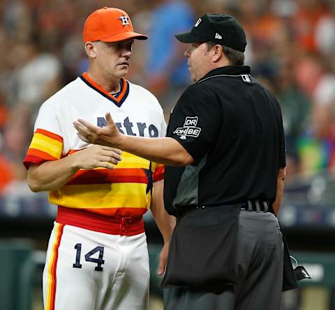 HOUSTON, TX – AUGUST 10: Manager AJ Hinch #14 of the Houston Astros talkas with home plate umpire Doug Eddings after Alex Bregman #2 argued he fouled the ball off his foot against the Seattle Mariners at Minute Maid Park on August 10, 2018 in Houston, Texas. (Photo by Bob Levey/Getty Images)