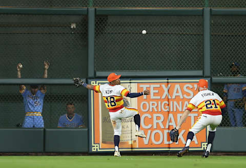 HOUSTON, TX – AUGUST 10: Tony Kemp #18 of the Houston Astros plays the ball off the wall as Derek Fisher #21 backs him up on a Nelson Cruz #23 of the Seattle Mariners double in ghe eighth inning at Minute Maid Park on August 10, 2018 in Houston, Texas. (Photo by Bob Levey/Getty Images)