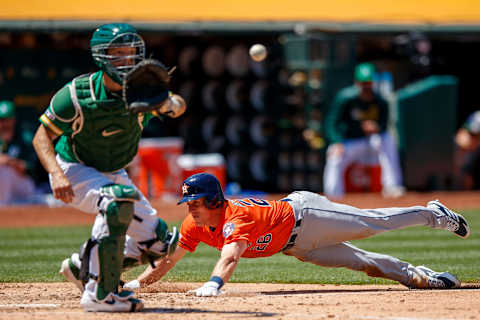 OAKLAND, CA – JUNE 02: Myles Straw #26 of the Houston Astros dives into home plate to score a run ahead of a tag from Nick Hundley #3 of the Oakland Athletics during the fifth inning at the Oakland Coliseum on June 2, 2019 in Oakland, California. (Photo by Jason O. Watson/Getty Images)