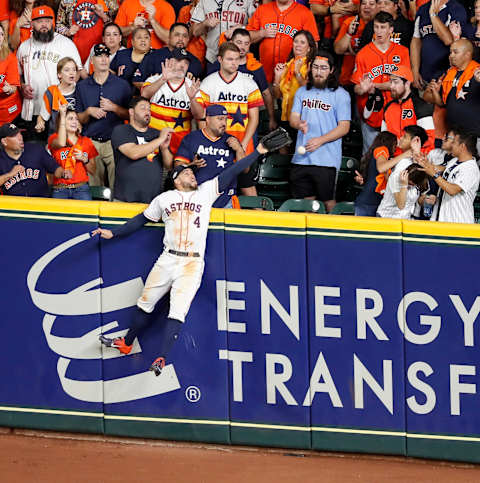 HOUSTON, TX – OCTOBER 19: George Springer #4 of the Houston Astros attempts to catch a home run by DJ LeMahieu #26 of the New York Yankees in the ninth inning during Game Six of the League Championship Series at Minute Maid Park on October 19, 2019 in Houston, Texas. (Photo by Tim Warner/Getty Images)