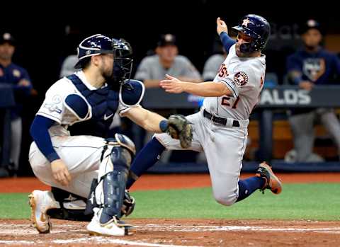 ST PETERSBURG, FLORIDA – OCTOBER 08: Jose Altuve #27 of the Houston Astros is tagged out at home plate by Travis d’Arnaud #37 of the Tampa Bay Rays while attempting to score a run during the fourth inning in game four of the American League Division Series at Tropicana Field on October 08, 2019 in St Petersburg, Florida. (Photo by Mike Ehrmann/Getty Images)