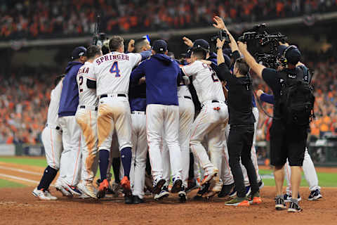 HOUSTON, TEXAS – OCTOBER 13: Carlos Correa #1 of the Houston Astros celebrates with teammates after hitting a walk-off solo home run during the eleventh inning against the New York Yankees to win game two of the American League Championship Series 3-2 at Minute Maid Park on October 13, 2019 in Houston, Texas. (Photo by Mike Ehrmann/Getty Images)