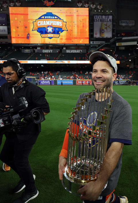 HOUSTON, TEXAS – NOVEMBER 05: Jose Altuve #27 of the Houston Astros lifts the commissioner’s trophy after defeating the Philadelphia Phillies 4-1 to win the 2022 World Series in Game Six of the 2022 World Series at Minute Maid Park on November 05, 2022 in Houston, Texas. (Photo by Harry How/Getty Images)