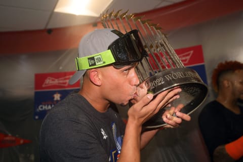 HOUSTON, TEXAS – NOVEMBER 05: Michael Brantley #23 of the Houston Astros celebrates in the clubhouse while holding the commissioner’s trophy after defeating the Philadelphia Phillies 4-1 to win the 2022 World Series in Game Six of the 2022 World Series at Minute Maid Park on November 05, 2022 in Houston, Texas. (Photo by Carmen Mandato/Getty Images)