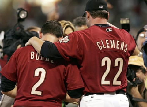 HOUSTON – OCTOBER 09: Winning pitcher Roger Clemens #22 of the Houston Astros puts his arm around Chris Burke #2 after Burke hit a solo home run to defeat the Atlanta Braves in Game Four of the 2005 National League Division Series on October 9, 2005 at Minute Maid Park in Houston, Texas. The Astros eliminated the Braves three games to one with a 7-6 victory in the 18th inning. (Photo by Doug Benc/Getty Images)