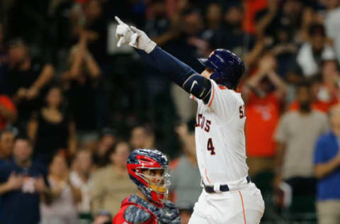 HOUSTON, TX – HOUSTON, TX – SEPTEMBER 24: Springer #4 of the Houston Astros celebrates a home run in the seventh inning as he crosses in front of Martin Maldonado #12 of the Los Angeles Angels of Anaheim at Minute Maid Park on September 24, 2017 in Houston, Texas. (Photo by Bob Levey/Getty Images)SEPTEMBER 24: George Springer