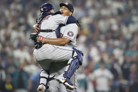 Luis Garcia #77 of the Houston Astros reacts with Christian Vazquez #9 after defeating the Seattle Mariners 1-0 in game three of the American League Division Series at T-Mobile Park on October 15, 2022 in Seattle, Washington. (Photo by Steph Chambers/Getty Images)