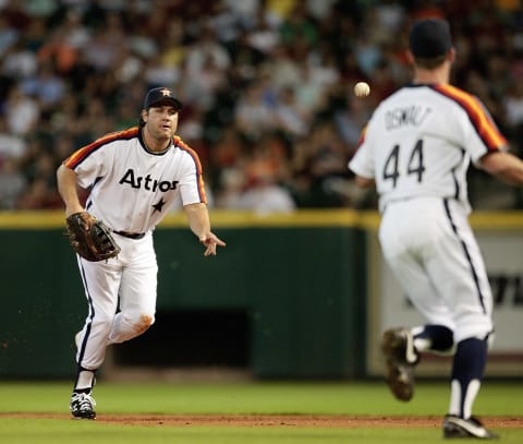 HOUSTON – JULY 24: First baseman Lance Berkman #17 tosses the ball to pitcher Roy Oswalt at first base against the Cincinnati Reds at Minute Maid Park on July 24, 2010 in Houston, Texas. (Photo by Bob Levey/Getty Images)