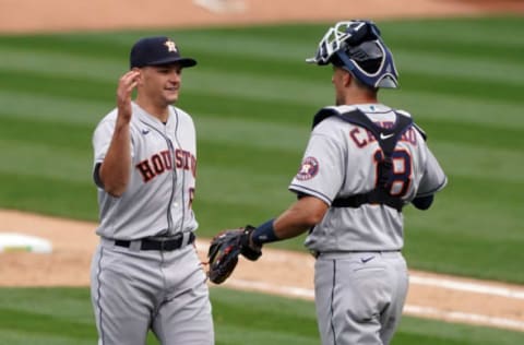 Apr 4, 2021; Oakland, California, USA; Houston Astros relief pitcher Brandon Bielak (64) celebrates with catcher Jason Castro (18) after the game against the Oakland Athletics at RingCentral Coliseum. Mandatory Credit: Darren Yamashita-USA TODAY Sports