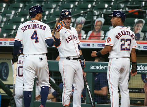 Aug 29, 2020; Houston, Texas, USA; Houston Astros center fielder George Springer (4) and designated hitter Michael Brantley (23) celebrate with right fielder Josh Reddick (22) after scoring runs during the first inning against the Oakland Athletics in game two of a double header at Minute Maid Park. Mandatory Credit: Troy Taormina-USA TODAY Sports