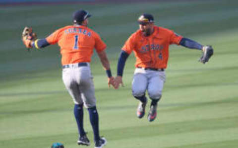 Oct 5, 2020; Los Angeles, California, USA; Houston Astros shortstop Carlos Correa (1) and center fielder George Springer (4) celebrate after game one of the 2020 ALDS against the Oakland Athletics at Dodger Stadium. Mandatory Credit: Jayne Kamin-Oncea-USA TODAY Sports