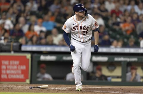 Houston Astros left fielder Trey Mancini (26) hits a sacrifice RBI against the Arizona Diamondbacks in the fourth inning at Minute Maid Park. Mandatory Credit: Thomas Shea-USA TODAY Sports