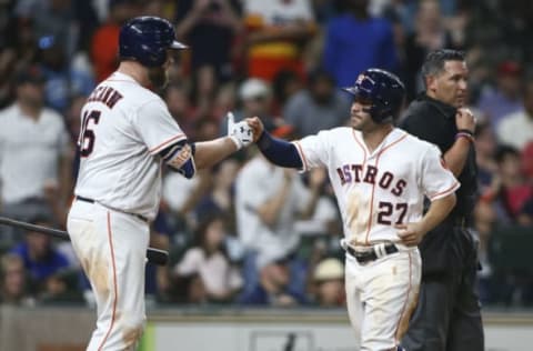 Jun 14, 2017; Houston, TX, USA; Houston Astros second baseman Jose Altuve (27) celebrates with catcher Brian McCann (16) after scoring a run during the fifth inning against the Texas Rangers at Minute Maid Park. Mandatory Credit: Troy Taormina-USA TODAY Sports