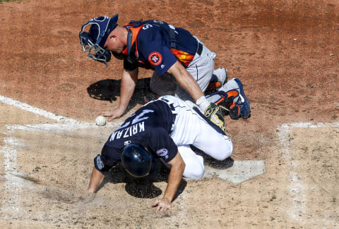 Feb 25, 2017; Lakeland, FL, USA; Detroit Tigers Jason Krizan (73) slides safely into home plate as Houston Astros catcher Max Stassi (12) tries to tag him in the fifth inning of a baseball game during spring training at Joker Marchant Stadium. Mandatory Credit: Butch Dill-USA TODAY Sports