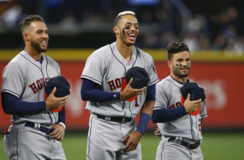 Apr 12, 2017; Seattle, WA, USA; Houston Astros center fielder George Springer (left) and shortstop Carlos Correa (1) and second baseman Jose Altuve (27) laugh following the completion of the national anthem before a game against the Seattle Mariners at Safeco Field. Mandatory Credit: Joe Nicholson-USA TODAY Sports