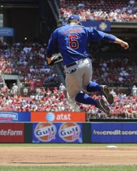 July 22, 2012; St. Louis, MO. USA; Chicago Cubs first baseman Bryan LaHair (6) clicks his heels, in honor of Ron Santo, as he runs onto the field in the first inning against the St. Louis Cardinals at Busch Stadium. Mandatory Credit: Jeff Curry-USA TODAY Sports