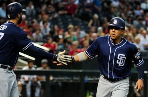 May 27, 2016; Phoenix, AZ, USA; San Diego Padres center fielder Jon Jay (24) celebrates with right fielder Matt Kemp (27) after scoring in the third inning against the Arizona Diamondbacks at Chase Field. Mandatory Credit: Matt Kartozian-USA TODAY Sports