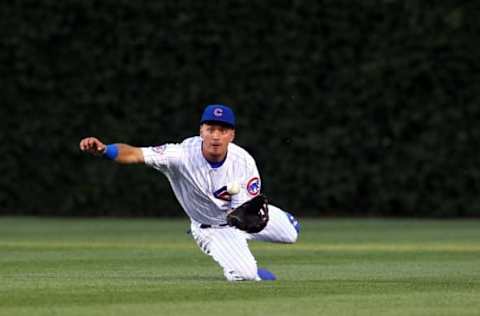 Jun 21, 2016; Chicago, IL, USA; Chicago Cubs left fielder Albert Almora Jr. (5) makes a diving catch during the third inning against the St. Louis Cardinals at Wrigley Field. Mandatory Credit: Caylor Arnold-USA TODAY Sports