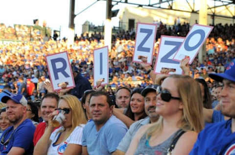 Aug 1, 2016; Chicago, IL, USA; Fans hold up signs for Chicago Cubs first baseman Anthony Rizzo (not pictured) while at bat during the first inning against the Miami Marlins at Wrigley Field. Mandatory Credit: Patrick Gorski-USA TODAY Sports