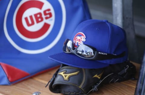 Chicago Cubs cap and glove in the dugout (Photo by Ralph Freso/Getty Images)