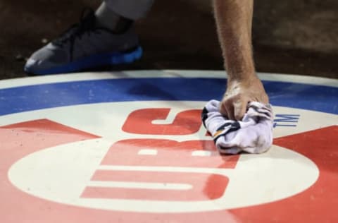 CHICAGO, IL – OCTOBER 15: A Chicago Cubs grounds crew member cleans off the Chicago Cubs logo prior to game one of the National League Championship Series against the Los Angeles Dodgers at Wrigley Field on October 15, 2016 in Chicago, Illinois. (Photo by Jonathan Daniel/Getty Images)