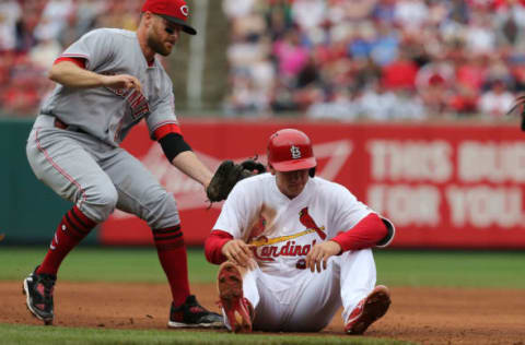 ST. LOUIS, MO – APRIL 30: Stephen Piscotty #55 of the St. Louis Cardinals is caught in a run-down by Zack Cozart #2 of the Cincinnati Reds in the eighth inning at Busch Stadium on April 30, 2017 in St. Louis, Missouri. (Photo by Dilip Vishwanat/Getty Images)