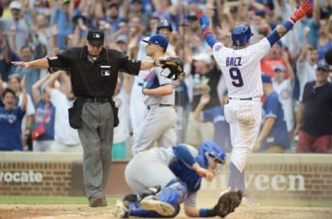 CHICAGO, IL – AUGUST 20: Javier Baez #9 of the Chicago Cubs beats a tag at home plate by Raffy Lopez #1 of the Toronto Blue Jays to score the winning run during the tenth inning at Wrigley Field on August 20, 2017 in Chicago, Illinois. (Photo by Stacy Revere/Getty Images)