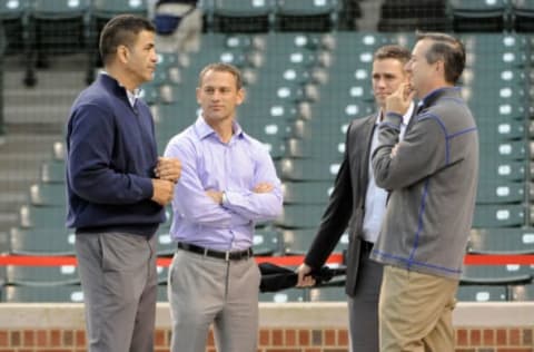 CHICAGO, IL – SEPTEMBER 15: (L-R) Jason McLeod, senior vice president of player development; general manager Jed Hoyer; Theo Epstein, president of baseball operations; and owner Tom Ricketts of the Cubs talk before a game against the Cincinnati Reds on September 15, 2014 at Wrigley Field in Chicago, Illinois. (Photo by David Banks/Getty Images)