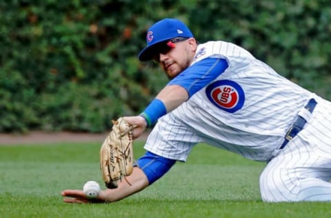 CHICAGO, IL – SEPTEMBER 17: Kyle Schwarber #12 of the Chicago Cubs is unable to make a catch on a ball hit by Yadier Molina #4 of the St. Louis Cardinals during the sixth inning at Wrigley Field on September 17, 2017 in Chicago, Illinois. (Photo by Jon Durr/Getty Images)