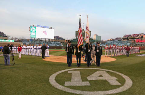 CHICAGO, IL – APRIL 05: Members of the Chicago Cubs and the St. Louis Cardinals stand for the National Anthem before the Opening Night game at Wrigley Field on April 5, 2015 in Chicago, Illinois. (Photo by Jonathan Daniel/Getty Images)