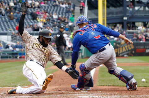 PITTSBURGH, PA – APRIL 23: Josh Harrison #5 of the Pittsburgh Pirates slides into home plate past Wellington Castillo #5 of the Chicago Cubs after scoring the go-ahead run in the seventh inning during the game at PNC Park on April 23, 2015 in Pittsburgh, Pennsylvania. (Photo by Jared Wickerham/Getty Images)