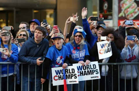 Nov 4, 2016; Chicago, IL, USA; Chicago Cubs fans cheer and take photos during the World Series victory parade on Michigan Avenue. Mandatory Credit: Jerry Lai-USA TODAY Sports