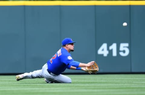 May 9, 2017; Denver, CO, USA; Chicago Cubs left fielder Kyle Schwarber (12) is unable to bring in a fly ball by Colorado Rockies catcher Ryan Hanigan (not pictured) allowing three runs to score in the third inning at Coors Field. Mandatory Credit: Ron Chenoy-USA TODAY Sports