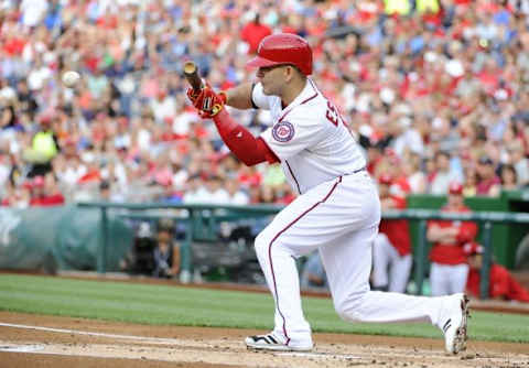 Apr 23, 2015; Washington, DC, USA; Washington Nationals second baseman Danny Espinosa (8) bunts the ball against the Los Angeles Dodgers during the first inning at Nationals Park. Espinosa was safe on a throwing error. Mandatory Credit: Brad Mills-USA TODAY Sports