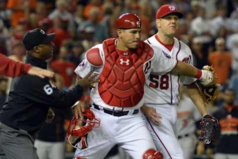 Sep 23, 2015; Washington, DC, USA; Washington Nationals catcher Wilson Ramos (40) holds back relief pitcher Jonathan Papelbon (58) after he hit Baltimore Orioles third baseman Manny Machado (not pictured) with a pitch during the ninth inning at Nationals Park. Baltimore Orioles defeated Washington Nationals 4-3. Mandatory Credit: Tommy Gilligan-USA TODAY Sports