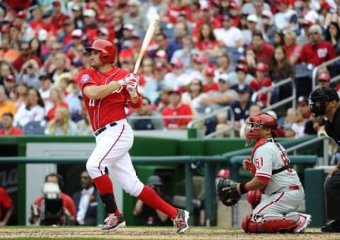 Apr 19, 2015; Washington, DC, USA; Washington Nationals first baseman Ryan Zimmerman (11) hits an RBI single against the Philadelphia Phillies during the seventh inning at Nationals Park. Mandatory Credit: Brad Mills-USA TODAY Sports