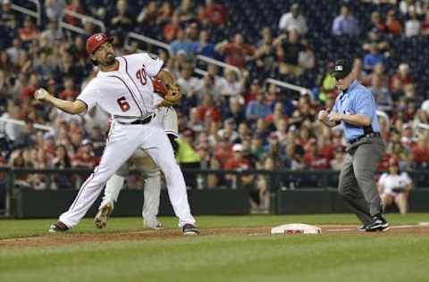 Apr 26, 2016; Washington, DC, USA; Washington Nationals third baseman Anthony Rendon (6) looks to throw first base to complete the double play after tagging out Philadelphia Phillies third baseman Maikel Franco (7) fifth inning at Nationals Park. Mandatory Credit: Tommy Gilligan-USA TODAY Sports