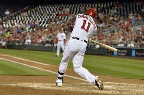 Apr 26, 2016; Washington, DC, USA; Washington Nationals first baseman Ryan Zimmerman (11) hits a rbi single scoring third baseman Anthony Rendon (not pictured) during the fifth inning against the Philadelphia Phillies at Nationals Park. Mandatory Credit: Tommy Gilligan-USA TODAY Sports