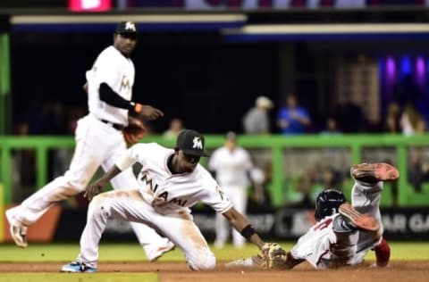 Apr 18, 2016; Miami, FL, USA; Miami Marlins second baseman Dee Gordon (9) tags out Washington Nationals center fielder Michael Taylor (3) at second base during the seventh inning of a game against the at Marlins Park. Mandatory Credit: Steve Mitchell-USA TODAY Sports