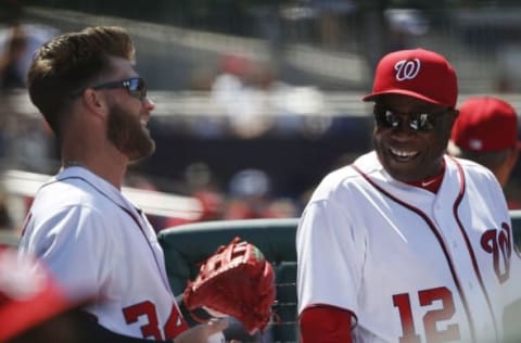 Apr 24, 2016; Washington, DC, USA; Washington Nationals manager Dusty Baker (12) smiles while talking with Nationals right fielder Bryce Harper (34) in the dugout against the Minnesota Twins in the fourth inning at Nationals Park. The Nationals won 5-4 in sixteen innings. Mandatory Credit: Geoff Burke-USA TODAY Sports