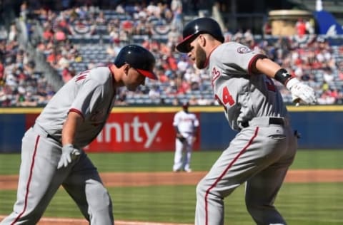 Apr 4, 2016; Atlanta, GA, USA; Washington Nationals right fielder Bryce Harper (34) reacts with first baseman Ryan Zimmerman (11) after hitting a home run against the Atlanta Braves during the first inning at Turner Field. Mandatory Credit: Dale Zanine-USA TODAY Sports