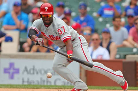 May 28, 2016; Chicago, IL, USA; Philadelphia Phillies center fielder Odubel Herrera (37) hits a bunt single during the first inning against the Chicago Cubs at Wrigley Field. Mandatory Credit: Dennis Wierzbicki-USA TODAY Sports