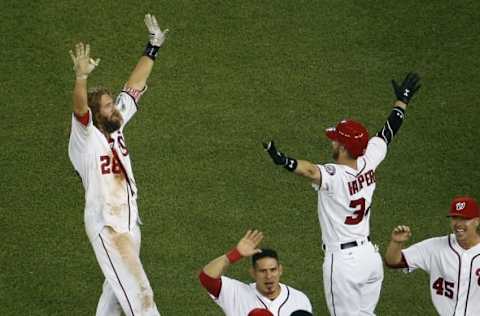 Jun 15, 2016; Washington, DC, USA; Washington Nationals left fielder Jayson Werth (28) celebrates with Nationals right fielder Bryce Harper (34) after hitting the game-winning single against the Chicago Cubs in the twelfth inning at Nationals Park. The Nationals won 5-4. Mandatory Credit: Geoff Burke-USA TODAY Sports