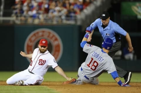 Jun 14, 2016; Washington, DC, USA; Chicago Cubs second baseman Ben Zobrist (18) doubles as Washington Nationals second baseman Daniel Murphy (20) looks on during the eighth inning at Nationals Park. Mandatory Credit: Brad Mills-USA TODAY Sports