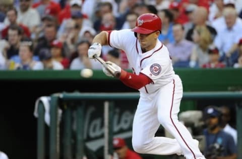 Jun 14, 2016; Washington, DC, USA; Washington Nationals shortstop Danny Espinosa (8) hits a bunt single against the Chicago Cubs during the third inning at Nationals Park. Mandatory Credit: Brad Mills-USA TODAY Sports