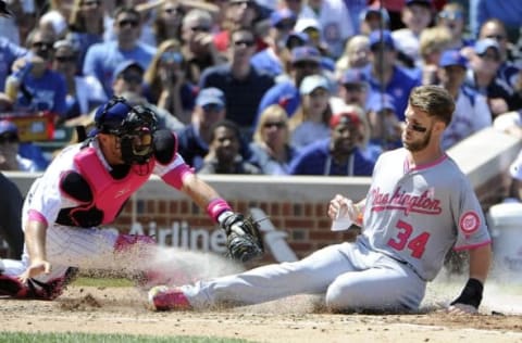 May 8, 2016; Chicago, IL, USA; Washington Nationals right fielder Bryce Harper (34) scores a run as Chicago Cubs catcher Tim Federowicz (15) makes a late tag during the third inning at Wrigley Field. Mandatory Credit: David Banks-USA TODAY Sports