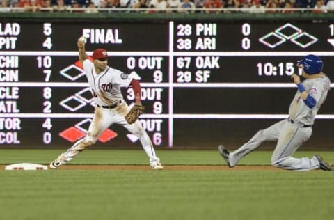 Jun 27, 2016; Washington, DC, USA; Washington Nationals shortstop Danny Espinosa (8) throws to first after the force out New York Mets third baseman Wilmer Flores (4) during the eighth inning at Nationals Park. Washington Nationals defeated New York Mets 11-4. Mandatory Credit: Tommy Gilligan-USA TODAY Sports